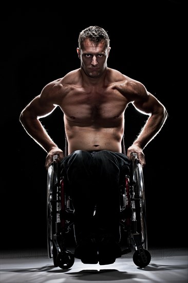 Muscular wheelchair user with a bare chest