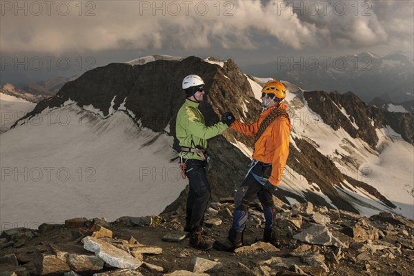 Mountain climbers congratulating one another following the ascent to the summit of Wilder Pfaff Mountain