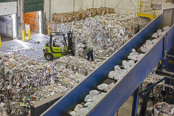 Low-wage workers sort paper