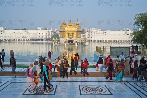 Sikh pilgrims walking around the Amrit Sagar or Holy Lake