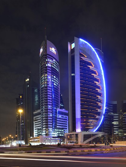Skyline of Doha at night with the Kahra Maa Tower and the Doha Bank Tower