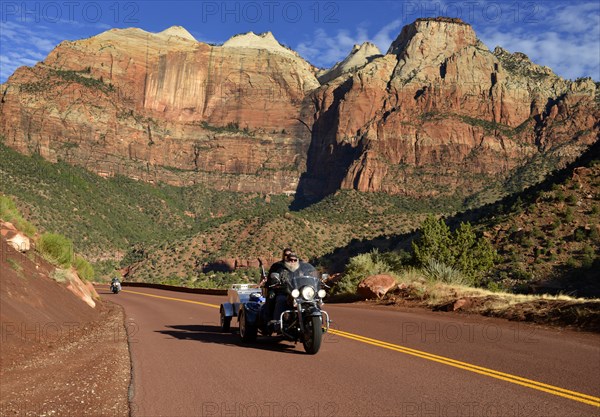 Harley Davidson motorcycle on the red road of Zion Park Boulevard - Mount Carmel U.S. Highway 9