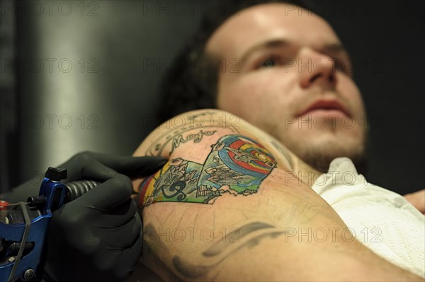 A young man is getting a tattoo