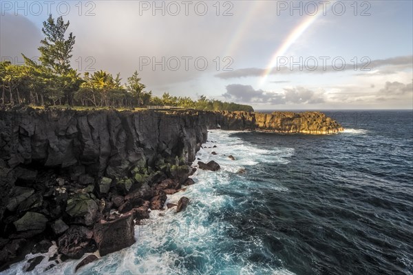 Rainbow and waves of a story sea at Cap Mechant