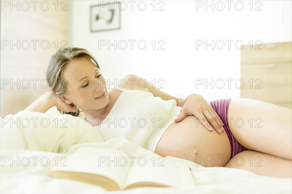 Pregnant woman lying in bed