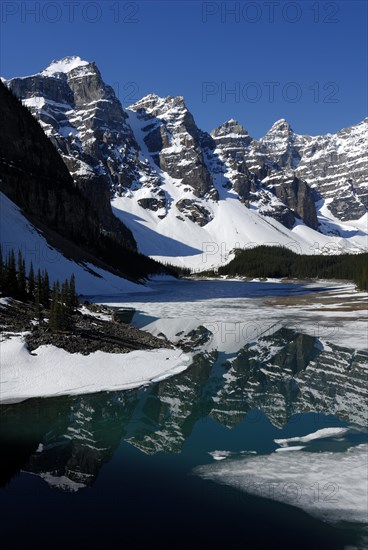 Wenkchemna Peaks mountain group reflected in the glacial Moraine Lake