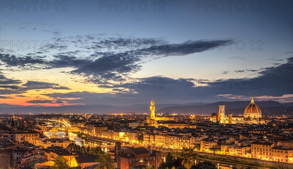 Illuminated city panorama at dusk with Florence Cathedral