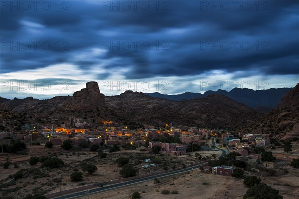 Small village of Aguard Oudad with brightly painted houses in front of the rock Chapeau Napoleon