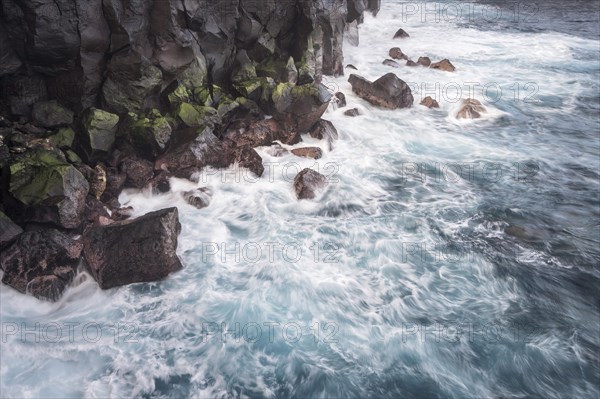 Waves of a stormy sea on the rocky coast at Cap Mechant