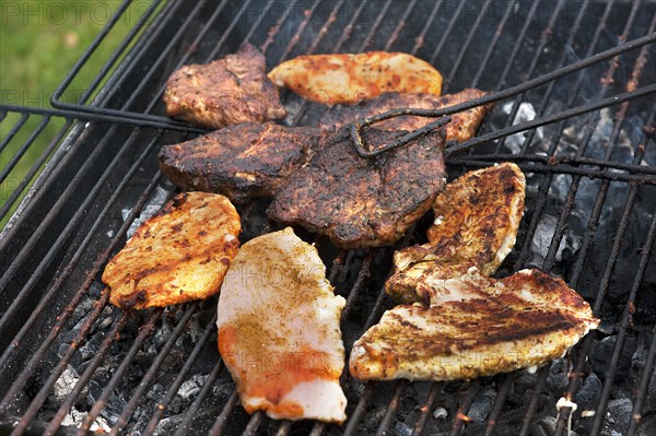 Heavily roasted meat on a charcoal grill