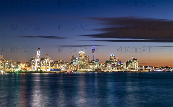 Illuminated skyline of Auckland at sunset