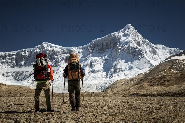 Hikers in front of mountain with glacier