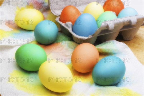 An assortment of colorful Easter eggs drying on paper towels