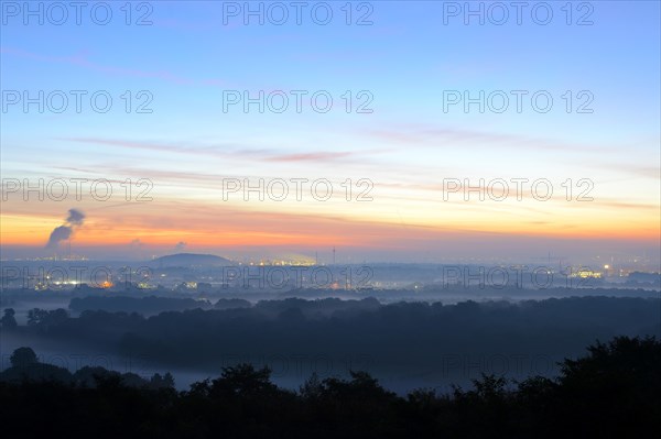 View from the Halde Norddeutschland spoil tip onto the Lower Rhine and the western Ruhr district at dawn