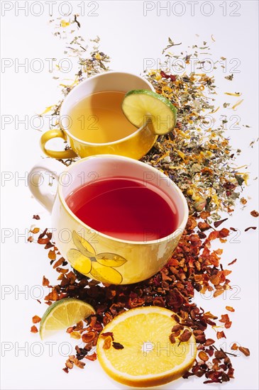 Cups with lemon slices and various fruit teas