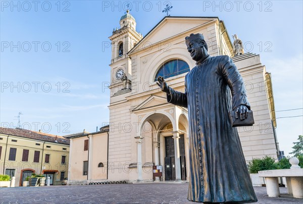 Statue of Don Camillo in Piazza Giacomo Matteotti in front of the Church of Santa Maria Nascente