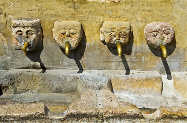 Four gargoyles by the village well