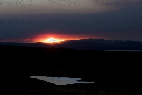 Sunset behind the ash and gas cloud of the Holuhraun fissure eruption