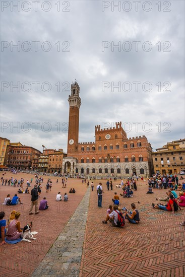 Tourists at the Palazzo Pubblico with Mangia Tower and Chapel