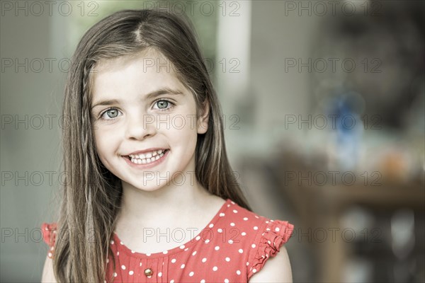 6-year-old girl looks into the camera