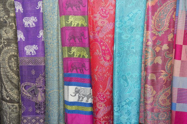 Various colorful scarves at a market