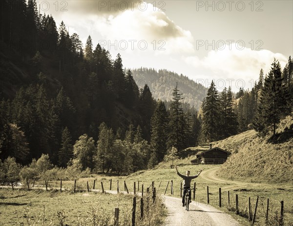 Young man riding a bicycle without his hands