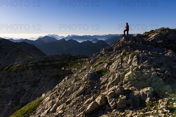 Peaks of the Allgau Alps in the early morning with a hiker