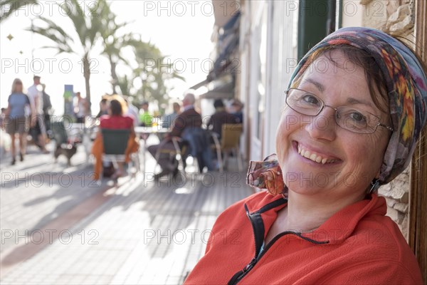 Woman sitting on a beach promenade