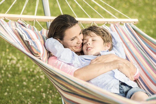 Mother and son lying in hammock