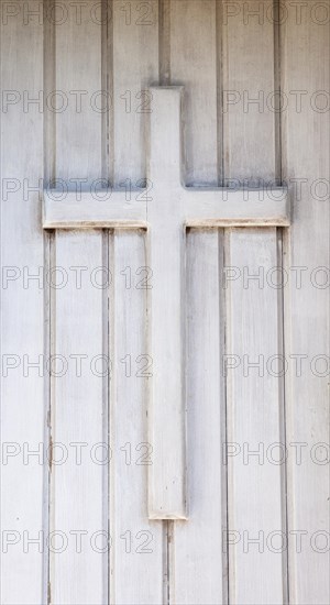 Wooden cross on the front door of a chapel