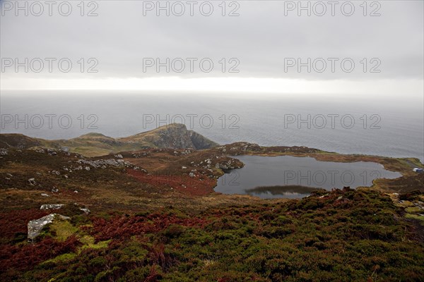 Lake at Slieve League or Sliabh Liag in front of the North Atlantic Ocean