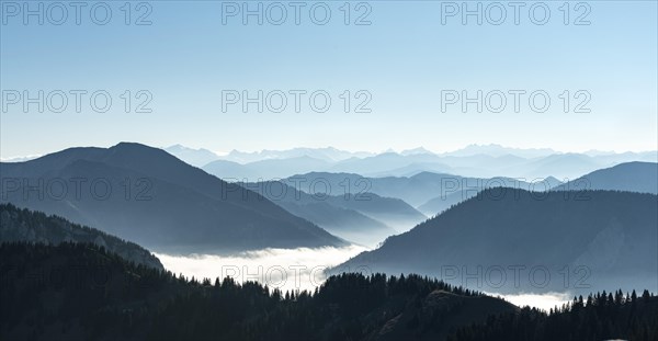 Mountain chains one behind the other in back light