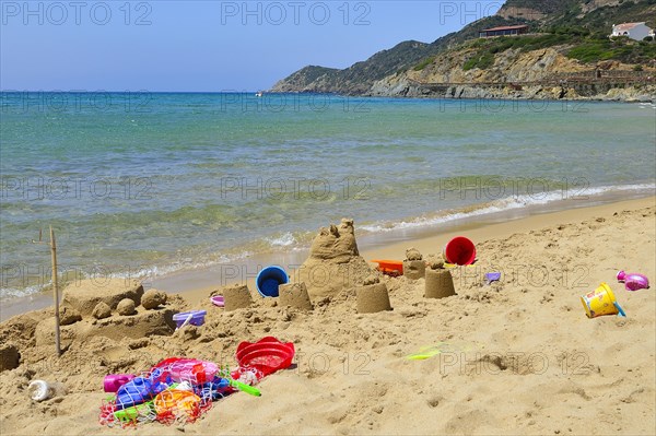 Sand castle and beach toys on the beach