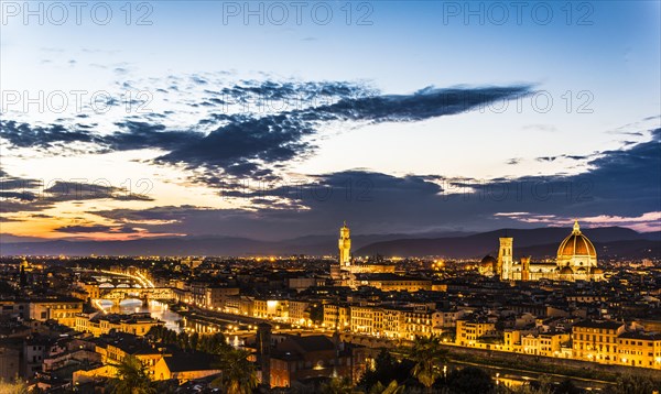 Illuminated city panorama at dusk with Florence Cathedral