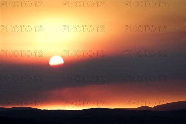 Sunset behind the ash and gas cloud of the Holuhraun fissure eruption