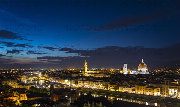 Illuminated city panorama at dusk with Florence Cathedral