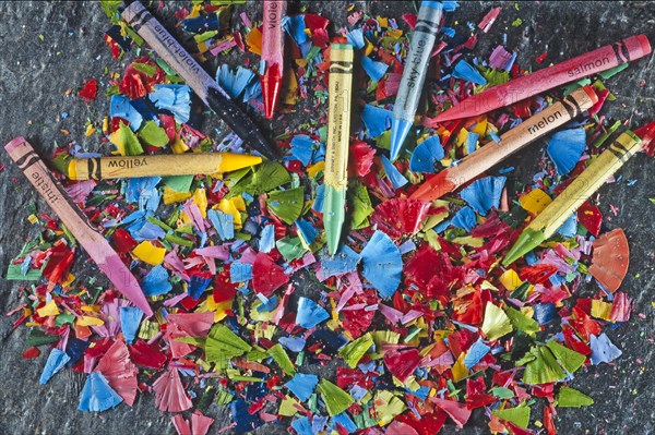 Colorful sharpened crayons on a slate