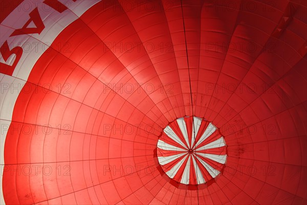 A red hot air balloon being inflated