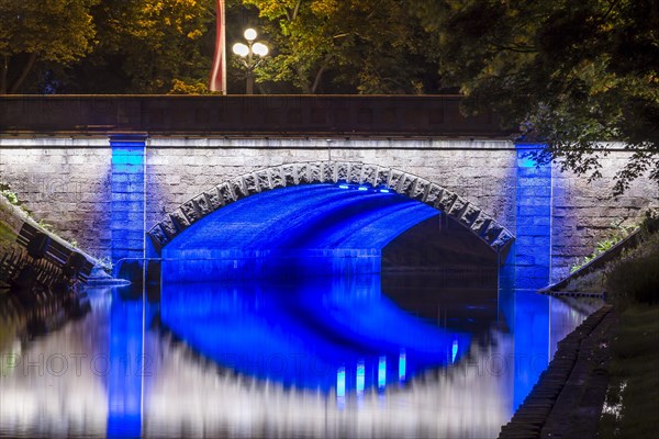 Illuminated bridge along the Pilsetas Canal
