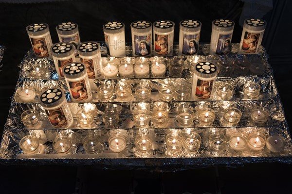 Burning votice candles in a church