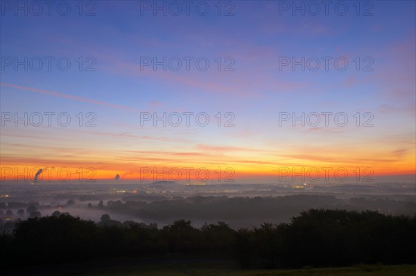 View from the Halde Norddeutschland spoil tip onto the Lower Rhine and the western Ruhr district at dawn