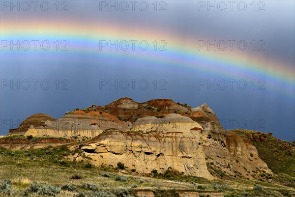 Rainbow over colorful badlands