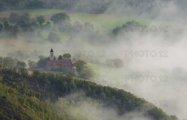 Aerial view of a small church in fog