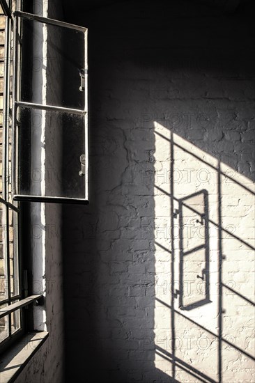 Light reflection of a window in the stairwell of a renovated factory