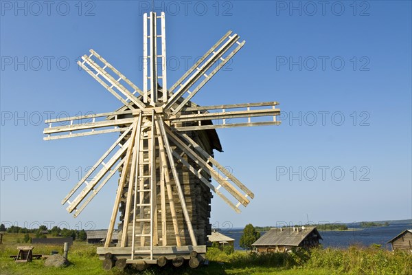 Old wooden windmill and houses
