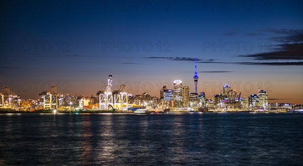 Illuminated skyline of Auckland at sunset