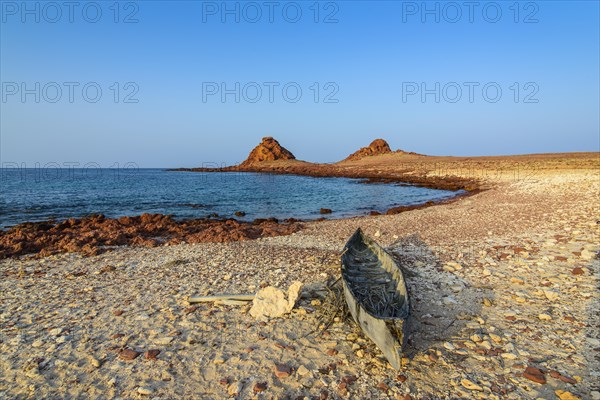 Little canoe on the rocky beach