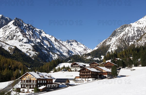 Mountain farms in a snow-capped mountain landscape