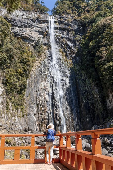 Tourist looks at Nachi Waterfall at Seigantoji Temple