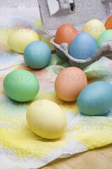 An assortment of colorful Easter eggs drying on paper towels